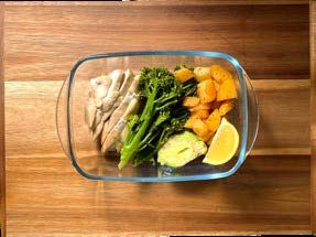 The finished plate: chicken, broccoli, roast potatoes, avocado and a lemon wedge